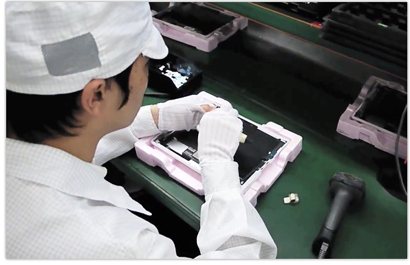 Foxconn workers assemble an iPad